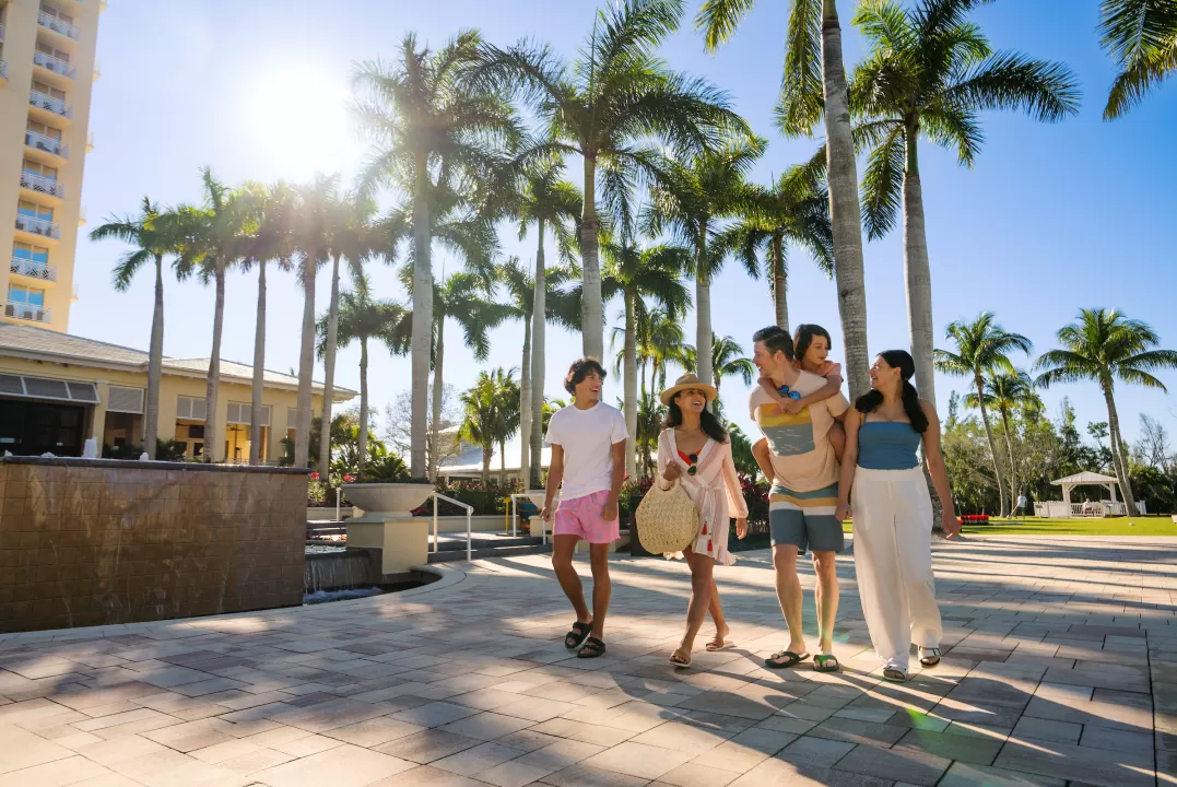 family walking outside at hyatt regency coconut point resort
