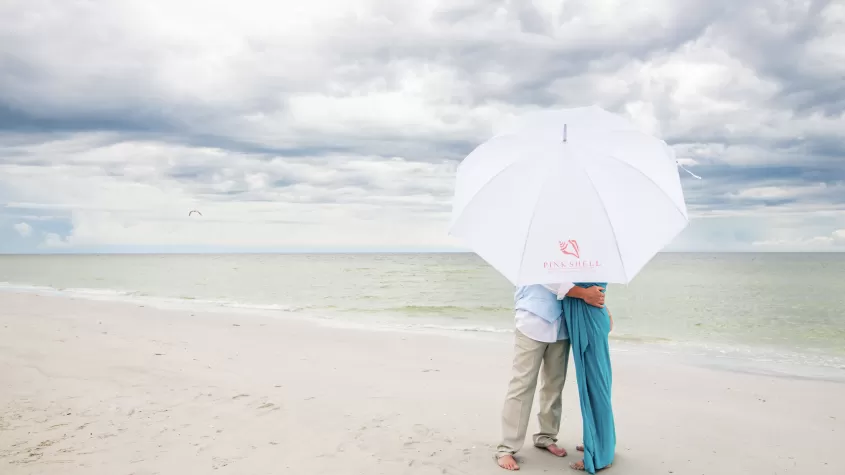 beach photo with pink shell resort umbrella