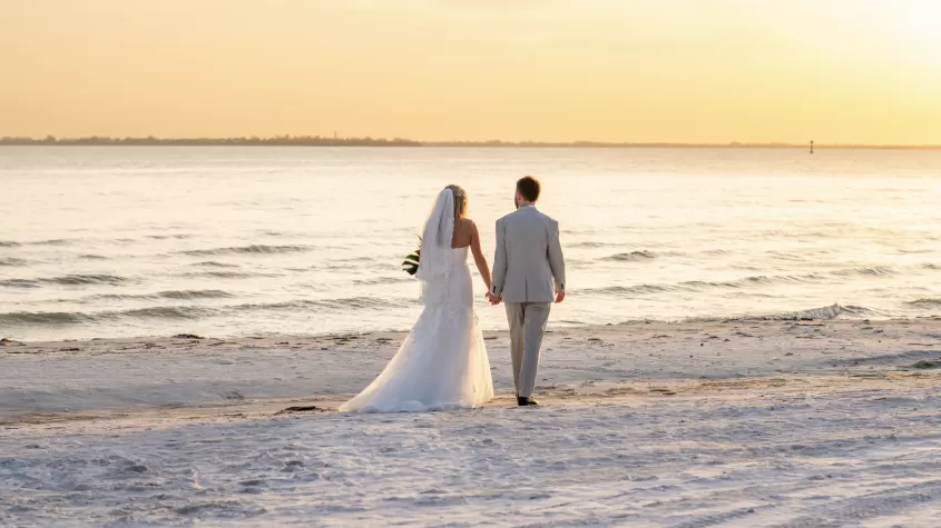 couple walking on beach, sunset