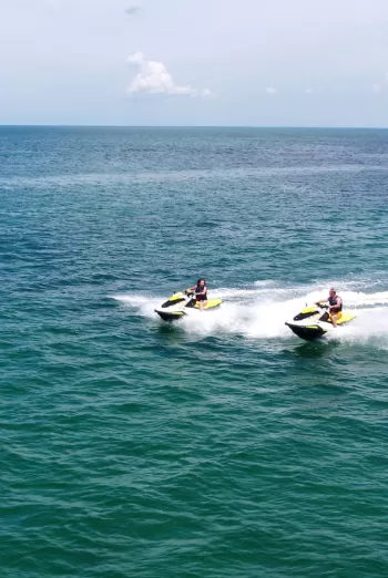 Couple zipping across the water on wave runners