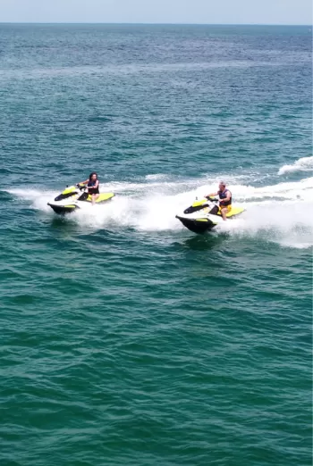 Couple zipping across the water on wave runners
