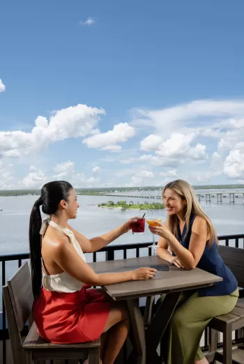 Women enjoying cocktails at a rooftop bar