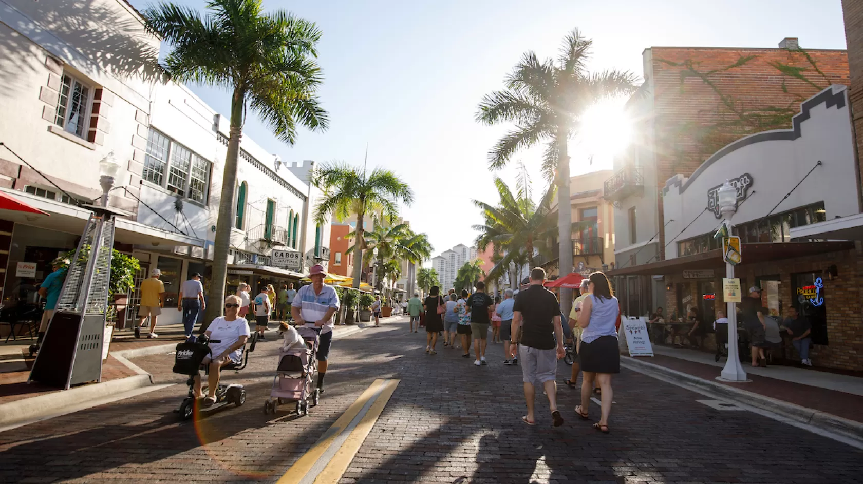 People walk in the street in downtown Fort Myers during an event