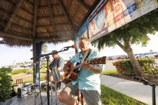 Artist singing under tiki hut