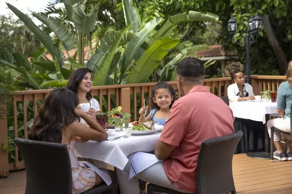 family dining on an outdoor deck